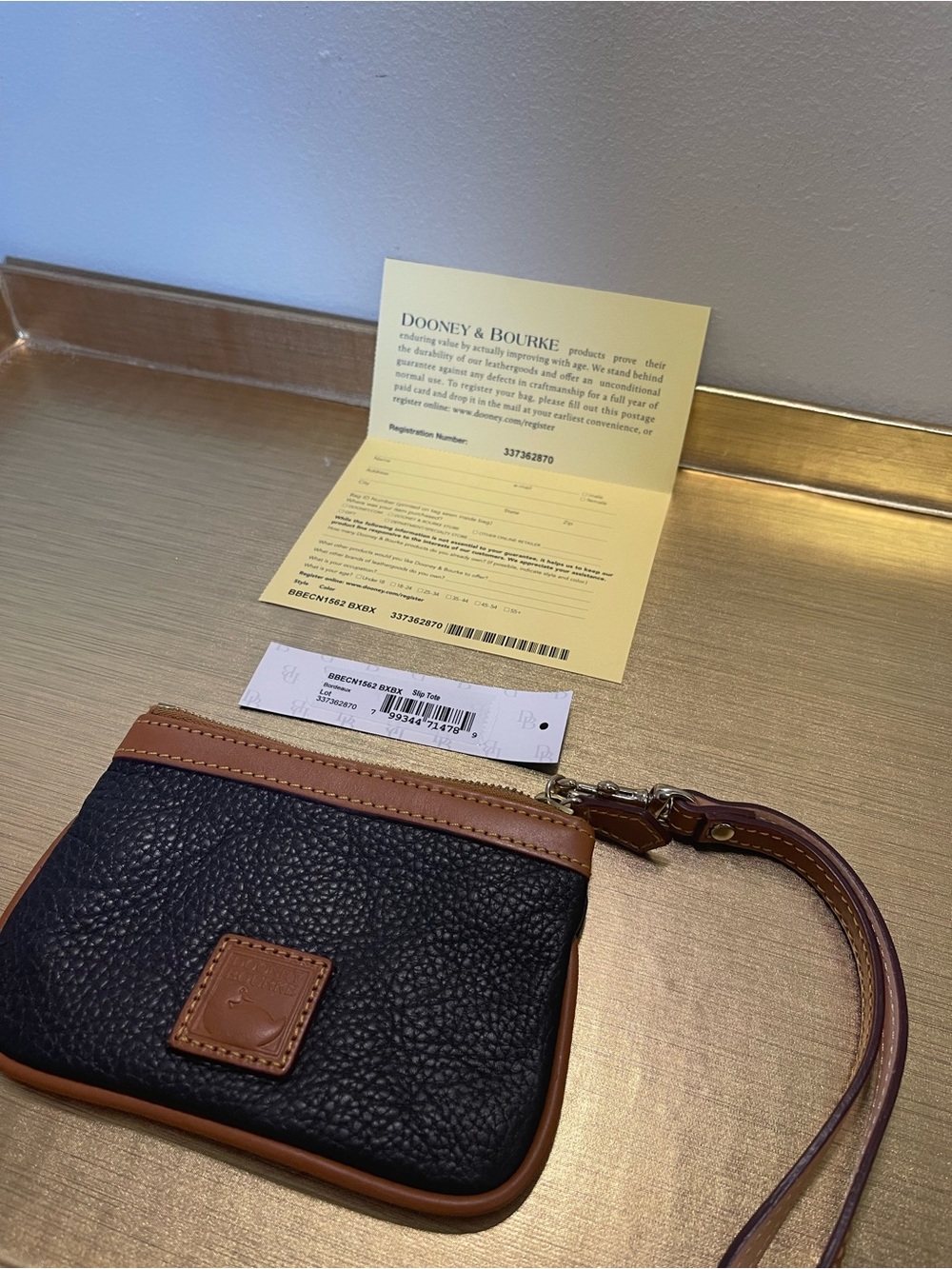 Dooney & Bourke Black Pebbled Leather Wristlet with Tan Trim and Strap